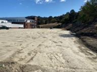 an expanse of dirt in a tennis court shape